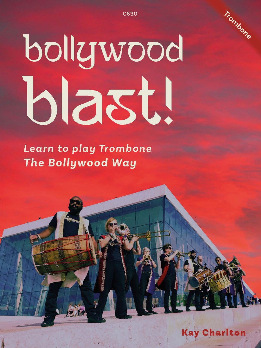 A book cover titled "Bollywood Blast! Learn to play Trombone The Bollywood Way" by Kay Charlton, featuring a group of musicians, including a dhol player and brass band members, in front of a modern building with a vibrant red and orange sky in the background.